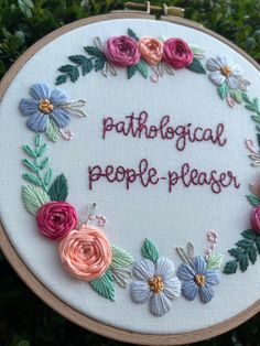 a cross stitch embroidery with the words, pathological people pleaser