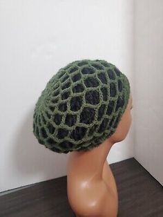 a mannequin head wearing a green and black hat