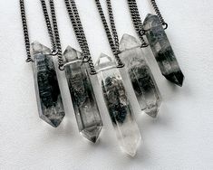 ✦ Tibetan Quartz Necklace ✦ Make this stunning black phantom quartz pendant your newest wardrobe staple! Striking yet simple, this versatile beauty is sure to look great with anything in your closet! ✧ Double terminated Tibetan Quartz w/ black and gray carbon inclusions ✧ 100% natural raw crystals, not cut or polished ✧ Crystal size 25-40mm long (1-1.6 inches) ✧ Select your favorite crystal from the dropdown menu ✧ Gunmetal chain in your chosen length ✧ Hypoallergenic steel chain on request ✧ St Tibetan Quartz, Gray Quartz, Double Terminated Crystal, Crystals Necklace, Raw Crystals, Quartz Crystal Pendant, Black Quartz, Gothic Necklace, Witchy Jewelry