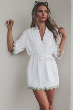 The perfect little kimono when heading anywhere sandy. White short sleeve kimono style dress, green trim detail on hems, adjustable tie belt at waist Material is Polyester Hang to dry Model is 5’9 wearing a small SHOP THE LOOK Small Medium Large Length 33” 34” 35” Bust 21” 22” 23” Kimono Style Dress, Short Sleeve Kimono, Sandy Shores, Amazing Lace, Native Style, Kimono Style, Shop The Look, White Short, Trim Detail