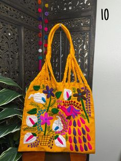 "Artisanal Handwoven Mexican Floral Tote Bag, great for your Beach or Boho look. Eco-friendly, super handy for groceries or to carry your books. Overview *Thread material *approximate measurements: 15\" tall x 16\" wide Care *hand wipe only *delicate care Please email me your questions before buying. All of my items come from a smoke and pet free environment. I WILL BE PROCESS YOUR ORDER IN 1-2 DAYS. If you need the item expressed shipped please contact me to request it and the listing will be a Traditional Tote Bag With Braided Handles, Bohemian Orange Bag For Shopping, Bohemian Orange Shopping Bag, Embroidered Natural Tote Shoulder Bag, Multicolor Rectangular Hobo Bag With Braided Handles, Traditional Woven Shopping Bags, Yellow Crochet Bag With Braided Handles For Shopping, Traditional Shoulder Bag With Braided Handles For Shopping, Double Handle Bags With Braided Handles For Market