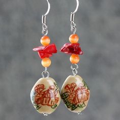 "The crocheted wiring necklace is handmade using hand painted ceramic, red coral, cat eye; with Sterling silver hook. A unique color palette of coral, peach and golden brown. Coral is vibrant and punchy, peach is soft and feminine, gold is luxury and elegant. The meaning of the Chinese writing on the ceramic is \"The flower is blossoming, the fortune is coming\". Who can resist this temptation? The length of the necklace is 17-19 inches, 43-48cm. The length is well suited to crew and high neckli Gift Red Coral Dangle Jewelry, Colorful Beads Resin Jewelry Gift, Handmade Apricot Jewelry With Round Beads, Handmade Bohemian Apricot Jewelry, Handmade Apricot Bohemian Jewelry, Red Coral Dangle Jewelry As Gift, Red Coral Dangle Jewelry For Gifts, Handmade Apricot Round Bead Jewelry, Handmade Coral Jewelry