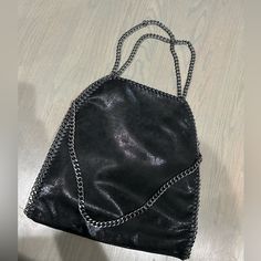 Brand New Gorgeous Black Vegan Leather Oversized Handbag! This Style Is Back And We Are Living For It! Zips Closed So Your Items Stay Inside Has Small Inside Pocket For Keys And Cards Or Small Items. Very Versatile Everyday Shoulder Bag Black Zipper, And Gunmetal Hardware Hard Stitching All Around The Sides Of The Bag Looks Just Like The Falabella Bag By Stella! This Is A Boutique Purchase, Amazing Quality Will Come With A Plain White Dust Bag For Storage And Safe Keeping Of Your New Purse! You Can Go Clean Girl Aesthetic Or Punk Rock With This Bag, This Bag Was Ironic In Early 2000s And Is Coming Back Again And Re-Released Recently! Any Questions Just Ask! Usa Ship Only Open To Black Bags With Chain Strap For Daily Use, Shopping Tote Bag With Chain Strap, Casual Black Bag With Chain Strap, Everyday Faux Leather Bag With Chain Strap, Faux Leather Bag With Chain Strap For Everyday Use, Top Handle Bag With Chain Strap For Night Out, Black Hobo Bag With Chain Strap, Black Hobo Bag With Chain Strap For Evening, Black Shoulder Bag With Chain Strap And Top Handle