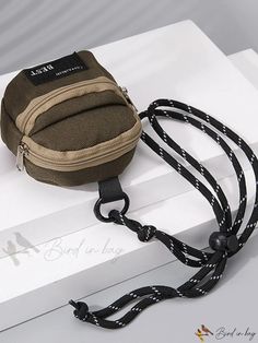 a small brown bag sitting on top of a white box next to a lanyard