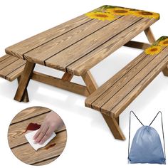 a wooden picnic table with sunflowers on it and a bag next to it