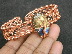 You will receive 1 Natural Labradorite Tree of life Wire Wrraped Bangle, Cuff bangle, Copper Wire, Handmade Gemstone Jewelry, beautiful bracelet, Gift for her.   Stone Size:    27 to 29   mm long    Many thanks for you visit my store ♥ if you have any question please contact us. For wholesale Price Please Convo me. You can order different items as many you like . Unique Hand Wrapped Bangle As Gift, Hand Wrapped Cuff Bracelet As Wearable Art Gift, Hand Wrapped Wearable Art Cuff Bracelet, Hand-wrapped Wearable Art Cuff Bracelet, Handmade Nature-inspired Bangle As Gift, Tree Of Life Wire, Diy Gemstone, Everyday Bracelet, Handmade Gemstone Jewelry