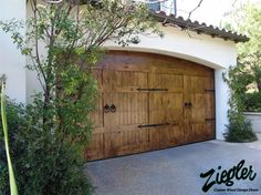 a wooden garage door in front of a house