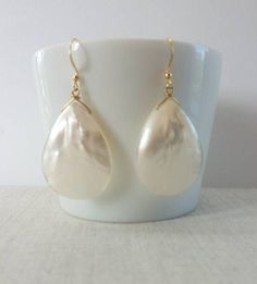 These beautiful earrings are made from real Mother of Pearl shells. These Mother of Pearl earrings are lightweight and very elegant. Beautiful as a Bride's Jewelry or as a Bridesmaid's Gift. The perfect choice for a unique gift to your mother, daughter, best friend or just because you deserve it. Each item is carefully packaged in an elegant jewelry box. If you would like to add a personalized note with your order, just write a note at checkout and I will send a small card with your gift to the Pearl White Teardrop Earrings With Pearl Drop, Handmade Teardrop Pearl Bridal Earrings, Pearl Drop Earrings For Bridal Shower, Pearl Shell Jewelry For Weddings, Elegant Shell Jewelry For Wedding, Wedding Pearl Shell Jewelry, Elegant Pearl White Jewelry For Beach, Elegant Shell Earrings For Gifts, Handmade Mother Of Pearl Earrings For Wedding