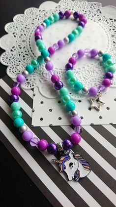 "Unicorn necklace set, kids jewelry, kids bracelet, party favor, purple, green, Unicorn jewellery, Unicorn jewelry. \" Be a Rainbow in someone else's cloud\" -Maya Angelou DETAILS and MEASUREMENT: Necklace: 20\" Bracelet: 6.5\" Made on stretchy cord. We can also put a clasp on it, for an extra $3.50 PLEASE NOTE: due to the high volume of orders, it is impossible for us to keep the same beads for all our orders, so the beads on your order may differ from the ones shown in the photo. if you would Green Unicorn, Jewelry Kids, Kids Bracelet, Bracelet Party, Unicorn Jewelry, Unicorn Necklace, Kids Bracelets, The One Show, Kids Collection