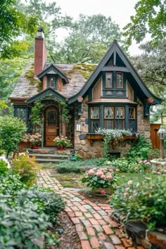 a house that is surrounded by flowers and trees