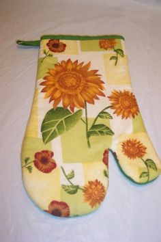 an oven mitt with sunflowers on it