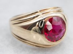 "This bezel set ring is crafted of yellow gold. A synthetic ruby sits in the center, a crimson-hued stone with flashes of cherry and vermilion. This ring would be great dressed up or down! Metal: 10K Yellow Gold Gem: Synthetic Ruby 2.30 Carats Gem Measurements: 8.4 mm, Round Ring Size: 7 Marks: \"RPL 10K\" Stamped on the inside band To view a video of this piece check out the link below: https://vimeo.com/816708194 SKU #: A25152 Each piece has been identified and graded by a Graduate Gemologist Aquamarine Solitaire Ring, Sapphire Solitaire Ring, Bezel Set Ring, Sapphire Solitaire, Set Ring, Gold Gift, Ruby Jewelry, Round Rings, July Birthstone