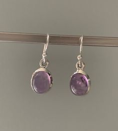 Amethyst oval earrings Silver Oval Earrings For Everyday, Silver Amethyst Earrings With Ear Wire, Oval Sterling Silver Earrings With Polished Finish, Silver Amethyst Gemstone Earrings, Sterling Silver Oval Pendant Earrings In Silver, Formal Silver Oval Cabochon Earrings, Silver Oval Pendant Earrings For Anniversary, Everyday Purple Amethyst Earrings, Purple Gemstone Earrings For Everyday Wear