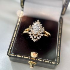 an antique diamond ring in a black box