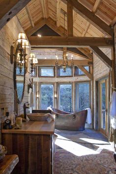 a bathroom with a tub and chandelier in the middle of it's walls