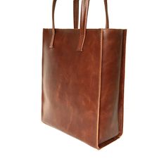 "Tote bag from SHleatnerBags keeps up with the times. The bag has clear lines and holds its shape well. At the same time, the bag is very roomy. Inside the bag there is a pocket with a zipper for small things. Dimensions: Small bag: Height: 11.81\" (30 cm) Width: 9.84\" (25 cm) Depth: 3.15\" (8 cm) Medium bag: Height: 13\" (33 cm) Width: 11.42\" (29 cm) Depth: 3.54\" (9 cm) Large bag: Height: 11.78\" (35 cm) Width: 11.81\" (30 cm) Depth: 5.12\" (13 cm)" Classic Square Box Bag With Leather Handles, Leather Handheld Shopping Bag, Everyday Square Leather Bag, Classic Rectangular Soft Leather Box Bag, Modern Tote Bag With Leather Lining, Square Leather Bag For Daily Use, Rectangular Leather Box Bag With Large Capacity, Leather Square Bag For Daily Use, Classic Box Bag With Double Handle For Gift