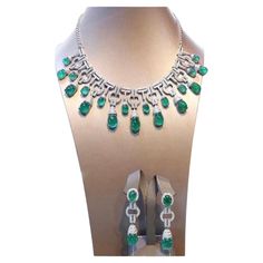 An exceptional Art Deco style parure, complete with earrings and necklace, so stunning and refined , a very piece of art. Necklace come in 18k gold with natural emeralds from Zambia, extra fine quality, in cabochon cut , Ceo Minor, of 91,85 carats, and 640 pieces of natural diamonds of 8,52 carats, F color and VS clarity. Earrings come in 18k gold with 4 pieces of natural emeralds from Zambia, extra fine quality ,Ceo Minor , of 26,76 carats, and 140 pieces of natural diamonds of 1,96 carats, rou Exquisite Diamond And Emerald Formal Necklace, Exquisite Diamond Emerald Necklace For Formal Occasions, Exquisite Emerald Necklace With Diamonds For Formal Events, Formal Emerald Necklace With Diamond Cut, Luxury Emerald Jewelry For Formal Occasions, Formal White Gold Emerald Necklace, Exquisite Hand-set Emerald Necklace For Formal Occasions, Elegant Emerald Necklace For Evening, Exquisite 17 Jewels Jewelry For Evening