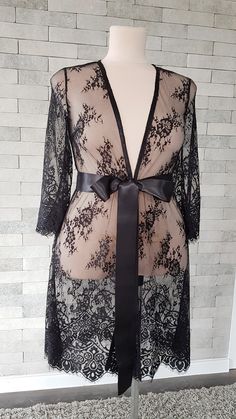 Black luxurious wedding robe, to add a perfect touch to your perfect and unique day. It can be made of high quality satin called Italian silk or natural silk. Only high quality fabrics and high finishing used for making the robe as neat as it can be. Please find the wedding robes collection here https://www.etsy.com/shop/LidiasBoutiqueDesign?ref=seller-platform-mcnav&section_id=25023222. For wedding dresses, please access https://www.etsy.com/shop/LidiasBoutiqueDesign?ref=seller-platform-mcn Black Lace Dress For Wedding Night, Black Lace Gown With Lace Sleeves, Elegant Black Bridesmaid Gown, Elegant Sheer Robe For Party, Elegant Lace Sleepwear, Black Dress With Lace Closure For Wedding, Sheer Lace Sleepwear For Party, Chic Lace Gown, Elegant Party Sleepwear With Delicate Lace