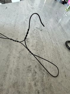 a pair of black headphones sitting on top of a counter next to a flower vase