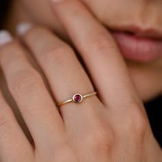 Ruby Ring 14K Gold Dainty Stacking Simple Red Stone Bezel Modern July Birthstone GR00218 A modern and timeless 14K gold ring with a natural Ruby gemstone. A perfect gold ring for women, stacking and minimalist that adds glam to every outfit. 100% handcrafted with love! ● Metal: 14K solid gold ● Gemstone: Natural Ruby ● Stone Diameter: 3.3mm R I N G ∙ S I Z I N G For General Reference: ● we use standard US Ring Sizing ● an average women's ring finger is size 6-7 ● each ring is custom made upon or Ruby Dainty Ring, Elegant Red Gemstone Stackable Rings, Red Stone Ring Women, Fine Jewelry Ruby In Yellow Gold, Dainty Round Jewelry With Smooth Bezel, Fine Jewelry In Yellow Gold With Ruby, Dainty Jewelry With Bezel Setting In Recycled Gold, Dainty Recycled Gold Jewelry With Bezel Setting, Fine Jewelry Sapphire Ring With Smooth Bezel For Anniversary