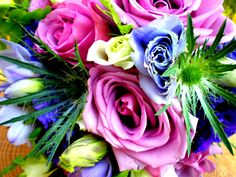 a bouquet of colorful flowers sitting on top of a table