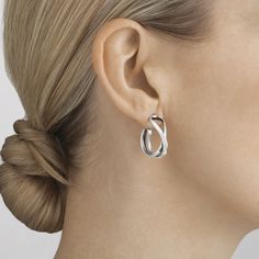 Taking as inspiration the mathematical symbol for infinity, with all its connotations of endless love, these small twists of sterling silver make elegant and sophisticated earhoops. The fluid minimal shapes coil around the ear lobe, acting as a discrete enhancement of a woman’s natural beauty and stand as classic examples of contemporary Scandinavian design. Regitze Overgaard is renowned for her sensuous and minimal jewellery collections for Georg Jensen. Her use of organic natural shapes reveal Small Twists, Infinity Hoop, Georg Jensen Jewelry, Contemporary Scandinavian, Infinity Earrings, Scandinavian Jewelry, Minimal Shapes, Infinity Jewelry, Stylish Bracelet