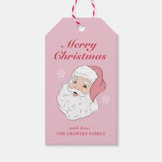 a pink christmas gift tag with a santa claus face on it and the words merry christmas