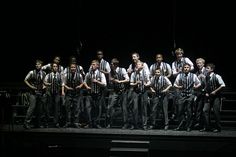 a group of men standing on top of a stage