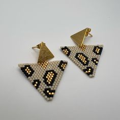 Description: Dainty Triangle Leopard Print Miyuki Earrings These Items Are Individually Made With Love By Me Details: Handmade Item Materials: Miyuki Seeds & 18k Gold Hypo-Allergenic Stainless Steel Posts Includes Rubber Backs Color: Gold, White, & Black Shape: Triangle Dimension: 2” Style: Boho Chic / Animal Print / Stylish Care Instructions: Store Out Of Direct Sunlight And Keep Away From Water. Leopard Print Bead Pattern, Handmade White Triangle Beaded Earrings, Handmade White Beaded Earrings Trendy Style, Handmade Trendy White Beaded Earrings, Handmade White Trendy Beaded Earrings, White Handmade Trendy Beaded Earrings, Trendy White Dangling Bead Earrings, White Triangle Earrings For Gift, Trendy White Dangling Beads Earrings