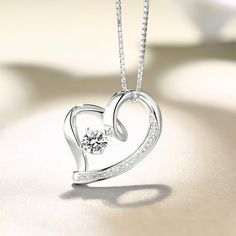 On Valentines Day, there is nothing more meaningful than a heart pendant with a birthstone. It is a truly great gift to express your love to your dearest one. The necklace is made of .925 sterling silver with a gem on the middle which can be personalized with a birthstone of your choosing. The Love In Your Heart Personalized Pendant Necklace arrives with a velvet jeweler's pouch and presentation box, perfect for safekeeping or gift giving. Celebrate the eternal nature of true love with this excl Heart-shaped Cubic Zirconia Birthstone Necklace, Heart-shaped Birthstone Necklace In Cubic Zirconia, Sterling Silver Heart Birthstone Necklace, Anniversary Heart Pendant Necklace With Gemstone, Elegant Gemstone Heart Necklace For Anniversary, Heart Cut Gemstone Birthstone Necklace Gift, Anniversary Gemstone Heart Pendant Necklace, Gemstone Heart Pendant Necklace For Anniversary, Gift Heart Cut Gemstone Birthstone Necklace