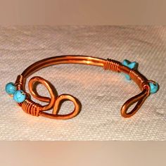 This Handmade Cooper Bangle Is So Cute...Makes A Great Gift Idea Or Keep For Yourself. This Bangle Is Ajustable And Fits For 6,7,Inch Wrist It's Fitted.It Has Semiprecious Stone Turquoise Beads.Comes With Free Gift. Cooper Jewelry Handmade, Handmade Copper Wire Bangle Bracelet, Handmade Copper Bangle In Brown, Handmade Unique Copper Bangle, Handmade Copper Spiritual Bangle, Unique Wire-wrapped Metal Bangle, Hammered Wire Jewelry, Handmade Copper Bracelet, Hammered Jewelry