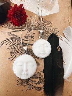 This enchanting Bone Pearl Moon Face necklace, set in sterling silver, captures the magic of the moon in a beautifully carved design. Available in two sizes, the moon face pendant radiates an ethereal charm, making it both a unique statement piece and a symbol of intuition and mystery. The bone pearl adds a natural, organic feel, while the sterling silver setting enhances its timeless elegance. Hanging from an 18" sterling silver ball chain, this necklace blends artistry and elegance, perfect for those who are drawn to the moon's quiet power. Ready to ship, it's a stunning piece for everyday wear or special occasions. White Mystical Pendant Jewelry, Mystical White Pendant Jewelry, Spiritual Moon Shaped Silver Jewelry, Spiritual Moon-shaped Silver Jewelry, Spiritual Silver Moon Jewelry, Mystical Round Engraved Jewelry, Spiritual Nickel-free Moon Shaped Jewelry, Nickel-free Moon Shaped Spiritual Jewelry, Moon Shaped Gemstone Spiritual Jewelry