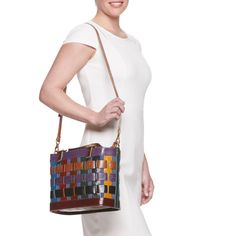 You're sure to love the colorful and unique style of this AmeriLeather basket-style handbag. You're sure to love the colorful and unique style of this AmeriLeather basket-style handbag. HANDBAG DETAILS 9"H x 5.5"W x 12.5"L Removable/adjustable crossbody strap Shoulder strap length: adjusts to 44 in. Adjustable handles Handle: 5.5'' drop Water repellent Copper-tone hardware Zipper closure Interior: 2 slip pockets, 1 zip pocketCONSTRUCTION & CARE Body: canvas/leather Wipe clean Imported Size: One Modern Multicolor Satchel With Detachable Handle, Leather Basket Shoulder Bag With Adjustable Strap, Leather Bucket Bag With Braided Handles In Basket Shape, Leather Basket Bag With Adjustable Strap, Modern Multicolor Shoulder Bag With Top Carry Handle, Modern Multicolor Shoulder Bag With Top Handle, Spring Leather Shoulder Bag With Woven Details, Leather Bucket Bag With Braided Handles For Spring, Spring Woven Leather Shoulder Bag