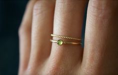 STUNNING handmade peridot ring set✨ * Listing covers both the peridot ring and twisted band. Beautiful 3mm peridot gemstone ✨ Peridot is a crystal that's not only rich in culture and history, but also mysticism and healing power. Peridot is rich with healing energies and spiritual connotations. Peridot can help to boost the confidence of those wearing it, as well as attracting luck and love✨ A beautiful minimalist piece to have in ones collection✨ Perfect for stacking or wearing alone! Material: Dainty Green 14k Gold Stackable Rings, Gold Stackable Rings With Peridot Birthstone, Minimalist Green Stackable Rings For Everyday, Minimalist Everyday Green Stackable Rings, Dainty Green Ring For Everyday, Minimalist Gold Stackable Rings For May Birthstone, Dainty Green Round Midi Rings, Minimalist Gold Stackable Rings With Emerald, Green Minimalist Stackable Rings