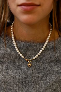 This freshwater pearl necklace features a central clasp with a gold puff heart. Style it with the emory heart necklace featured in the second photo for a love filled look. Details: - Freshwater pearls - Gold filled clasp - Gold plate brass heart charm - 16.5" length SKU: N1100G Materials+Care How To Style Pearl Necklace, Pearl Necklace Outfit, Necklace Outfit, Chunky Pearls, Layered Choker Necklace, Double Wrap Bracelet, Puffed Heart, Gold Pearl Necklace, Freshwater Pearl Necklace