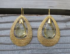 "A bohemian chic inspired handcrafted masterpiece in solid 18k Gold Large Hoop Earrings accented with Lemon Quartz. The earrings are hand carved giving way to a beautiful intricate texture, further accented with Lemon Quartz makes a timeless classic jewel. (e-124) Lemon Quartz(6.85cts) 11.5mm x 16.5mm Gold weight 15grams Drop length 2.5\" *Follow us @belesasjewelry on Instagram for promotions/giveaways *LIKE* us on Facebook http://www.facebook.com/Belesas *If you like the ring, please click on t Gold Bohemian Earrings With Gemstone Accents, Bohemian Gold Faceted Earrings, Gold Teardrop Earrings With Gemstone Accents, Gold Faceted Teardrop Hoop Earrings, Gold Elegant Hoop Earrings With Gemstone Accents, Luxury Gold Hoop Earrings With Gemstone, Luxury Gold Gemstone Hoop Earrings, Elegant Gold Hoop Earrings With Gemstone Accents, Bohemian Gold Drop Earrings