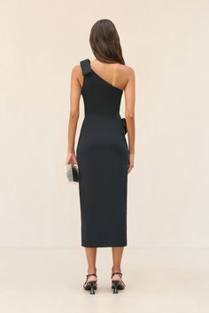 An artful knit midi dress with exaggerated bow details at the left shoulder and right hip. — Midi length — Compact knit fabric — Asymmetrical one-shoulder — Right hip cutout Icon Clothing, Evening Flats, Sandal Platform, Knit Midi, Knit Midi Dress, White Summer, Kids Boots, Kids' Dresses, Midi Length