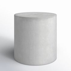 a white round stool on a plain surface with no one sitting at the top or standing up