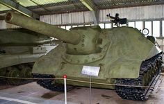 an army tank is on display in a building