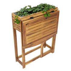 a wooden planter with plants growing out of it's sides on a white background