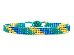 "Perfect for a pop of color! This turquoise \"skinny\" bracelet will charm your way through the day. Made using brilliant glass seed beads and premium nylon, these bohemian styled bracelets are dressed to impress and are a must-have every day accessory! Makes for a great birthday gift, Christmas gift, holiday gift, stocking stuffer, friendship bracelet and especially a \"just because\" gift for mom! Delicately handmade in Guatemala *Please note that all of our items are handcrafted and unique to Hand-strung Turquoise Beaded Bracelets For Summer, Adjustable Turquoise Wrap Bracelet With Tiny Beads, Turquoise Friendship Bracelets With Tiny Beads For Summer, Trendy Turquoise Bracelets With Tiny Beads, Turquoise Summer Friendship Bracelet With Tiny Beads, Turquoise Friendship Bracelet With Tiny Beads, Summer Friendship Bracelets With Tiny Turquoise Beads, Bohemian Blue Friendship Bracelets For Summer, Adjustable Turquoise Wrap Bracelet For Festival