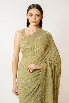 Olive green georgette saree with sequins and cutdana hand embroidery. Comes with a blouse.
Components: 2
Pattern: Hand embroidered
Type Of Work: Sequins, Cutdana
Neckline: Round
Sleeve Type: Sleeveless
Fabric: Georgette
Color: Green
Other Details: 
Closure: Blouse - Back hooks and tie-up
Occasion: Wedding - Aza Fashions Green Cutdana Pre-draped Saree For Evening, Pista Green Sequined Dupatta In Traditional Drape, Green Blouse Piece For Evening With Traditional Drape, Green Blouse Piece With Dupatta For Evening, Green Georgette Pre-draped Saree With Traditional Drape, Designer Green Pre-draped Saree With Mirror Work, Green Georgette Pre-draped Saree, Festive Green Pre-draped Saree With Mirror Work, Pista Green Pre-draped Saree With Sheer Dupatta For Reception