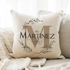 the personalized pillow is on top of a couch with pillows and blankets around it