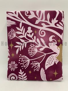 a purple and white flowered design on a maroon background with gold stars, leaves and swirls