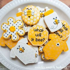 some decorated cookies are on a plate with honeycombs and beehive designs