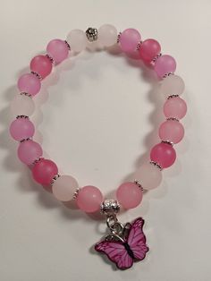 Shades of pink frosted glass beads 8mm Pink Butterfly Bracelet, Pink Glass Bead Bracelet, Pink Bracelets Ideas, Pink Charm Bracelet With Colorful Round Beads, Pink Rose Quartz Round Stretch Bracelet, Pink Rose Quartz Stretch Bracelet, Pink Stretch Bracelet With Spacer Beads As Gift, Adjustable Pink Charm Bracelet With 8mm Beads, Pink Charm Bracelet With Colorful Beads For Jewelry Making