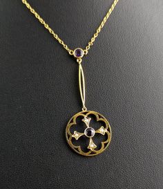 "The Art Nouveau era really opened up the world to some beautiful delicate jewels, like this beautiful antique, Art Nouveau era Amethyst and seed pearl pendant necklace. The pendant has an unusual cruciform design within a circular shaped pendant, set with a rich purple amethyst to the centre and four creamy pearls to each end of the cruciform shape. It is suspended from a slim gold drop with a round cut amethyst at the terminal to the chain, from there it is attached to a fine trace chain, all in a rich bloomed 9ct yellow gold. Such a pretty antique pendant with an unusual design. The chain is quite short so this will sit close to the neck and it fastens with a barrel clasp. Marks and era: It is marked on the clasp 9ct, Art Nouveau era, C1900s. Condition: Good used condition overall, some Vintage Necklace With Flower Pendant, Vintage Hallmarked Flower Pendant Necklace, Antique Hallmarked Flower Pendant Necklace, Art Deco Hallmarked Necklace As Gift, Art Deco Hallmarked Necklace For Gift, Heirloom Pendant Necklace With Rose Cut Diamonds, Gold Art Deco Necklace With Pearl Pendant, Gold Art Nouveau Necklace With Intricate Design, Art Nouveau Gold Necklace With Intricate Design