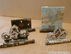 three pieces of metal sitting on top of a table