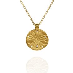 Gold vermeil Sand Dollar charm pendant and chain. This charm measures 1.5cm in diameter, which is 0.63 inches, and is hung from an 18” chain. It has been made using genuine gold vermeil. The correct definition of ‘Gold Vermeil’ is solid Sterling Silver that has been coated with a minimum of 2.5 microns of gold. Wearing a piece of Adrian Ashley’s jewellery identifies you as someone who can appreciate handmade goods and fine craftmanship. I do my best to insure all the raw materials I use have been sourced responsibly and I always price my work honestly. All pieces are handmade in a small workshop in the English countryside and shipped to collectors across the world. Prized by beach combers, sand dollars are often treasured mementos of a tropical holiday.Sand dollars are relatives of starfis Gold-plated Yellow Gold Charm Necklace With Round Pendant, Yellow Gold Plated Charm Necklace With Round Pendant, Gold Plated Yellow Gold Charm Necklace With Round Pendant, Gold Medallion Charm Necklace With Cable Chain, Yellow Gold Medallion Charm Necklace Amulet Style, Gold Charm Necklace With Round Pendant And Cable Chain, Yellow Gold Round Disc Brass Necklace, Gold Medallion Necklace With Cable Chain As Gift, Gold Brass Charm Necklace With Large Pendant