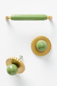 two green and gold knobs on white surface